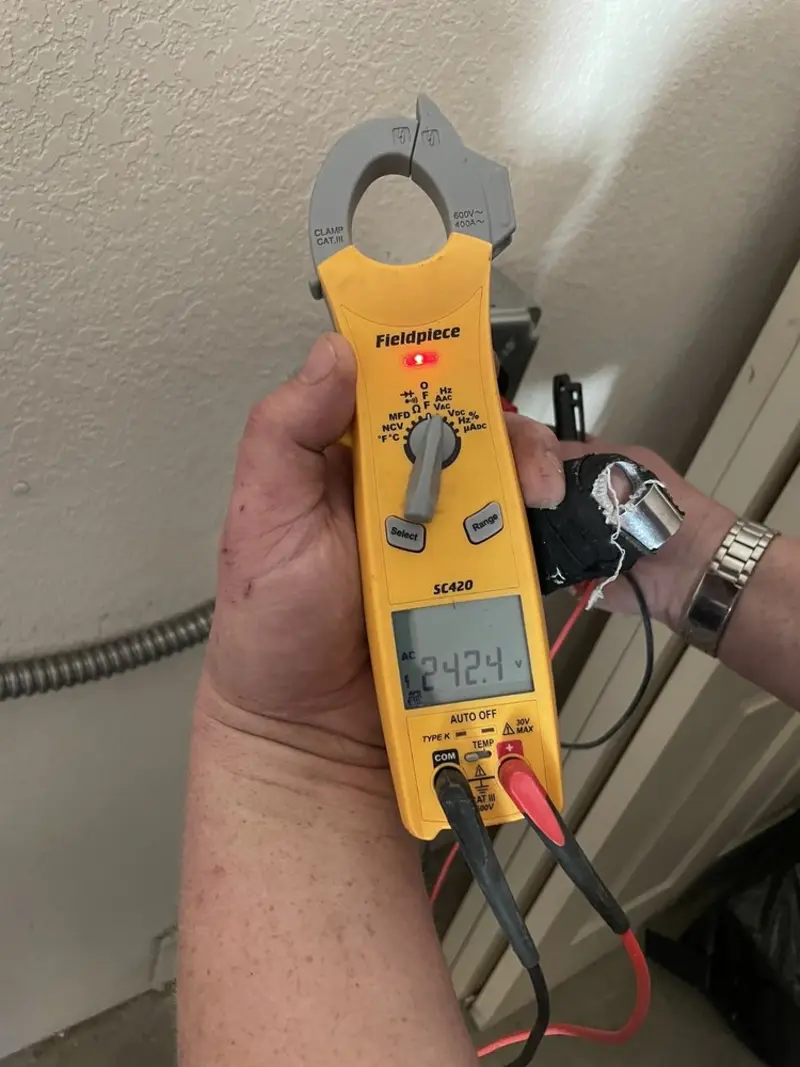 Voltage testing with clamp meter during Ceiling Fan Installation in North Fond du Lac
